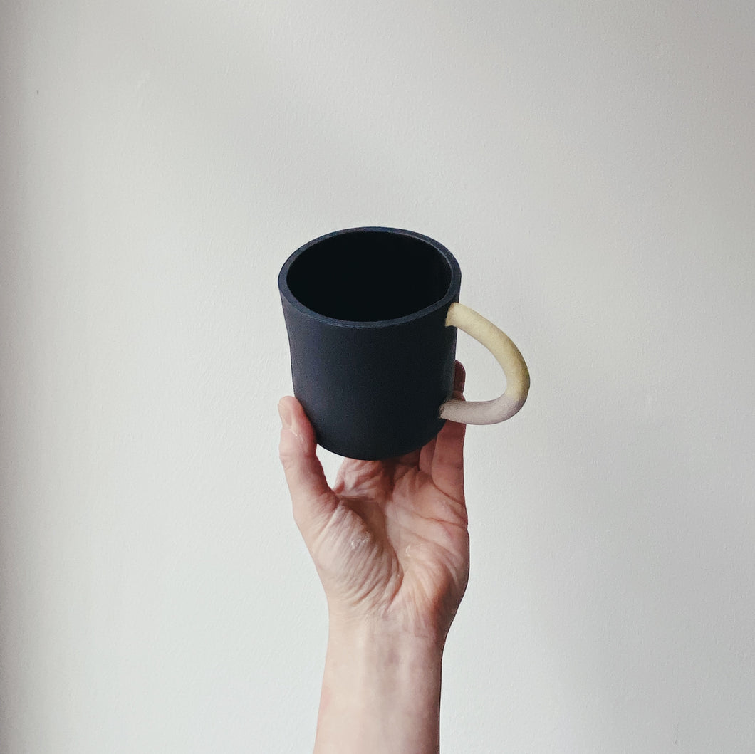 Black mug with yellow/lilac handle