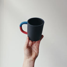 Load image into Gallery viewer, Black mug with blue/red handle
