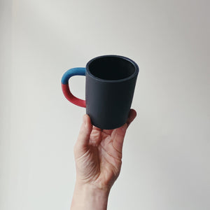 Black mug with blue/red handle