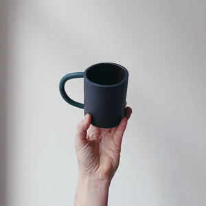 Black mug with green handle