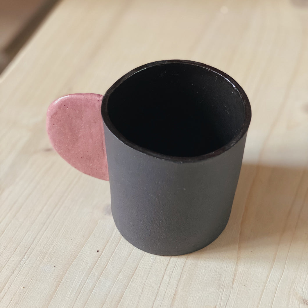 Black cup with pink handle
