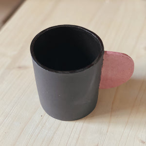 Black cup with pink handle