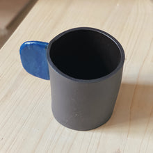 Load image into Gallery viewer, Black cup with blue handle
